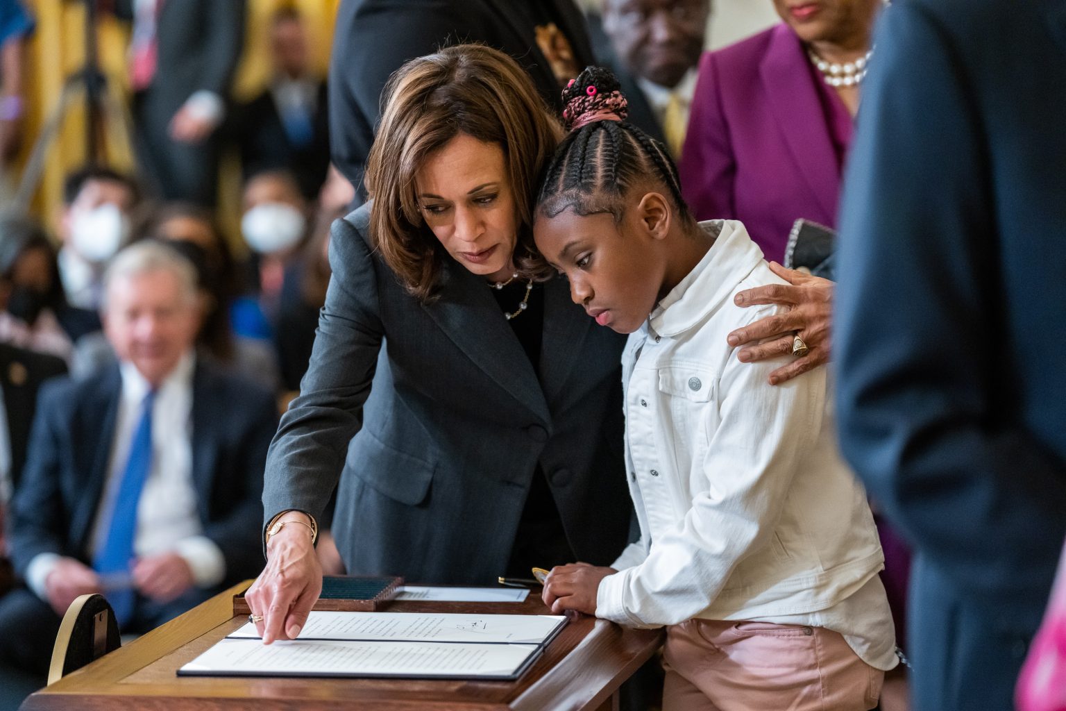 Vice President Kamala Harris shows Gianna Floyd, daughter of George Floyd, the executive order that President Joe Biden signed during an event on federal policing reforms, Wednesday, May 25, 2022, in the East Room of the White House. (Official White House Photo by Adam Schultz)