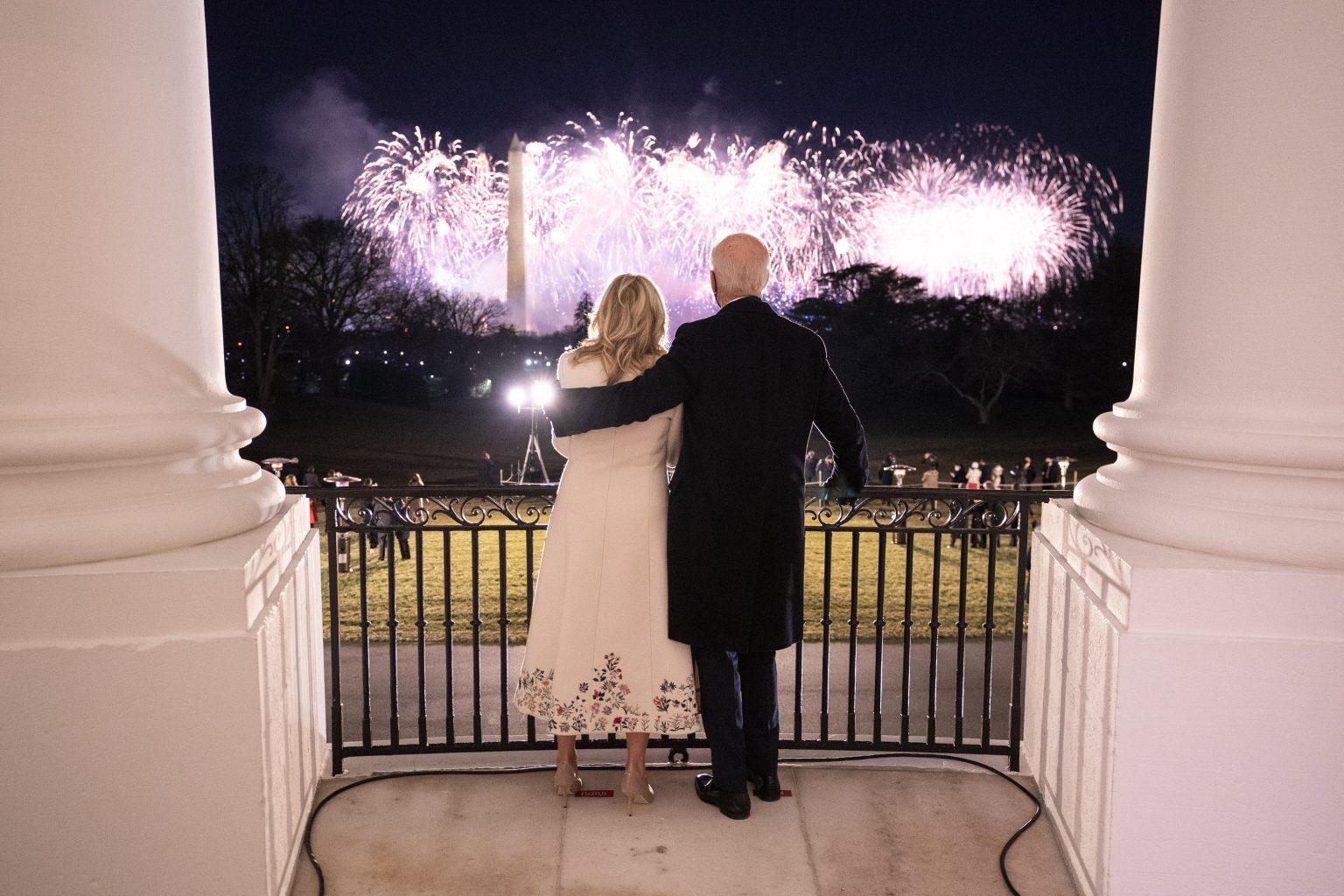 President Joe Biden puts his arm around First Lady Jill Biden as they watch fireworks from the Blue Room Balcony of the White House Wednesday, Jan. 20, 2021, during the "Celebrating America" event in honor of the 59th Presidential Inauguration. (Official White House Photo by Adam Schultz)