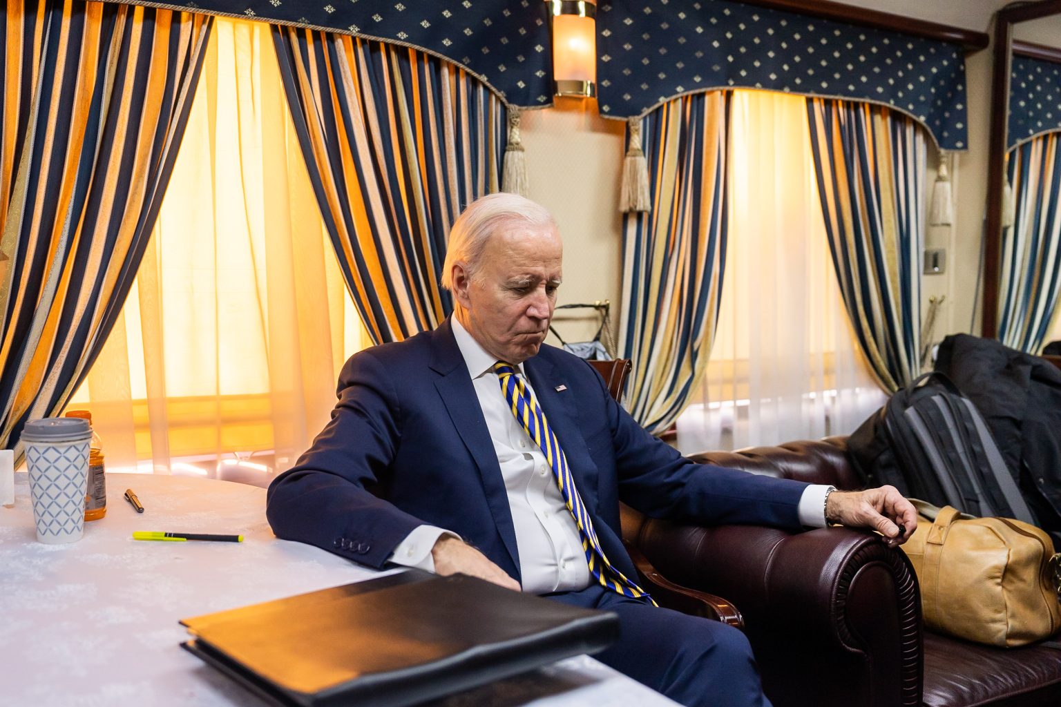 President Joe Biden talks with staff after working during the overnight train ride  from Przemysl Station in Poland Saturday, February 20, 2023, as they approach the Kyiv Train Station in Ukraine. (Official White House Photo by Adam Schultz)
