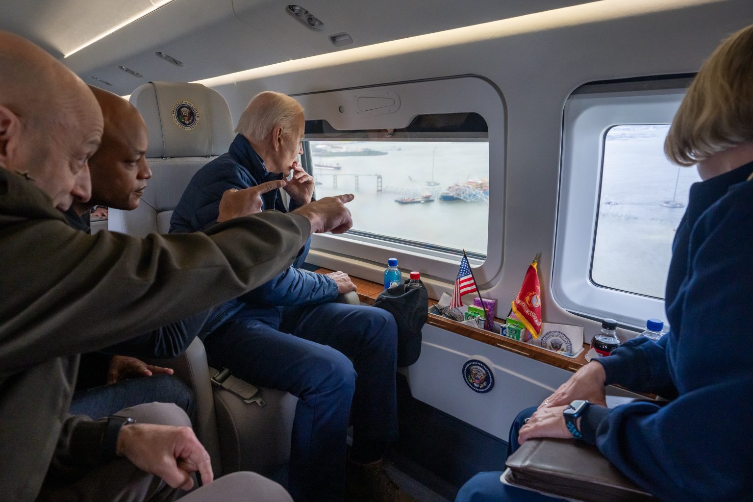 President Joe Biden, accompanied by Lieutenant General Scott Spellmon of the U.S. Army Corps of Engineers, U.S. Coast Guard Admiral Linda Fagan and Maryland Governor Wes Moore (D), views the collapsed Francis Scott Key Bridge in Baltimore from Marine One, Friday, April 5, 2024. (Official White House Photo by Adam Schultz)